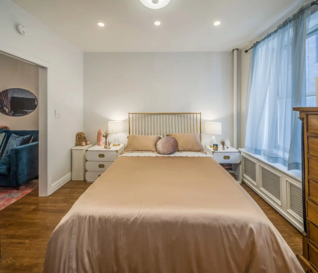 Bedroom with satin sheets and sheer curtains